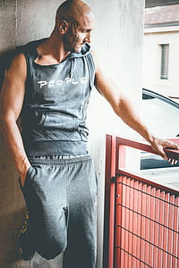 Man Wearing Grey Sleeveless Hoodie and Grey Sweatpants thumbnail