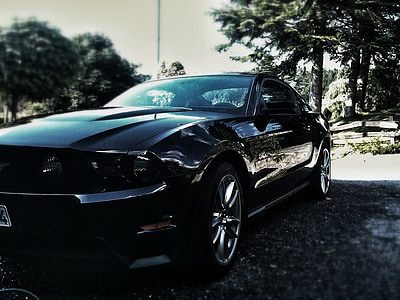 parked black Ford Mustang thumbnail