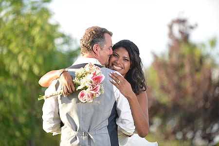 woman holding flowers hugging man thumbnail