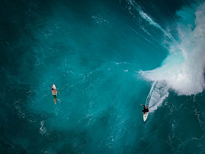 two person surfing on body of water thumbnail