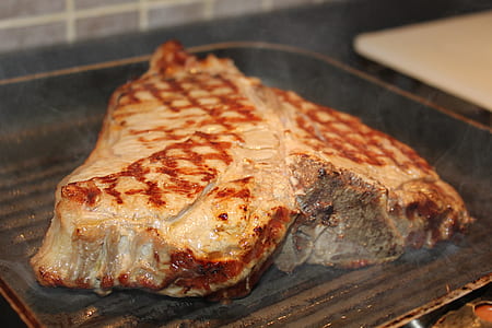 grilled meat on top of black metal grilling pan thumbnail