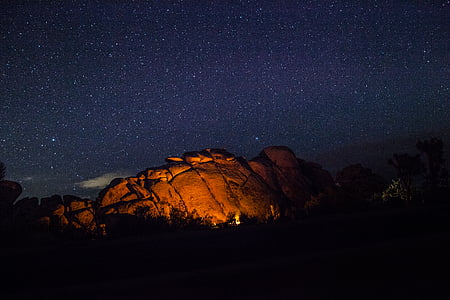 flame near rock under starry night thumbnail