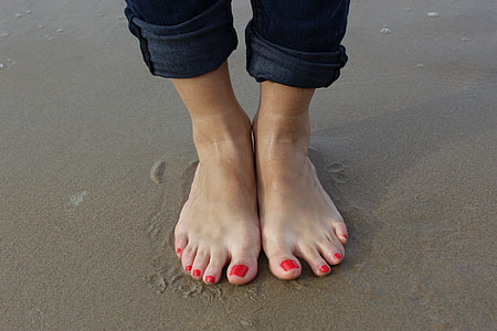 person standing on brown wet sand thumbnail