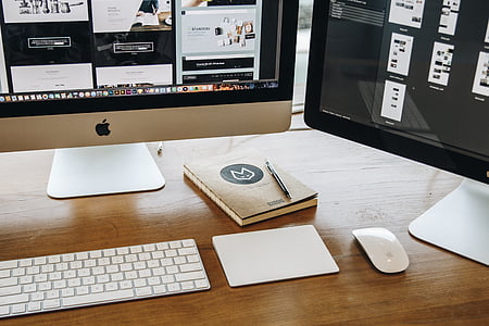 Apple Magic Mouse on table near corded computer keyboard thumbnail
