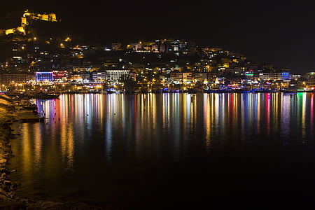 buildings near body of water at nighttime thumbnail