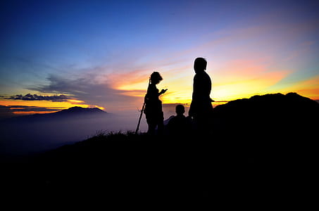 silhouette of three persons atop mountain thumbnail