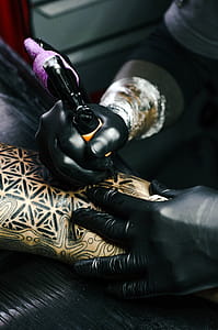 Selective Focus Photography of Tattoo Artist Drawing A Tatoo thumbnail