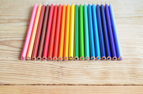 assorted-color pencils on beige wooden panel thumbnail