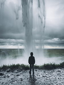 person standing facing on geyser photograph thumbnail