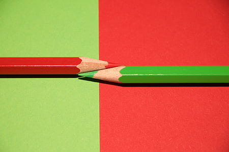 two green and red color pencils on inverted color surface thumbnail