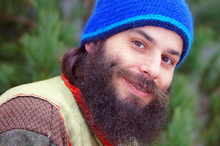 man in blue knit cap wearing brown vest thumbnail
