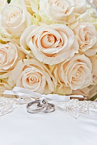white flower bouquet and two silver-colored rings thumbnail
