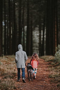 dog in between of adult and girl thumbnail