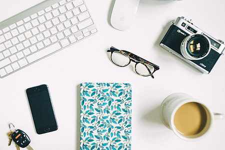 clear eyeglasses with frames beside black compact camera thumbnail