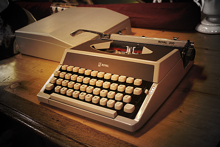 gray and brown typewriter on table thumbnail