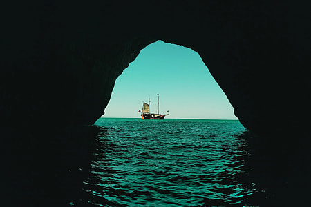 View of a boat from an ocean water cave thumbnail