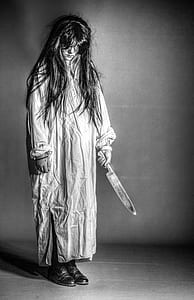 black haired girl holds knife thumbnail