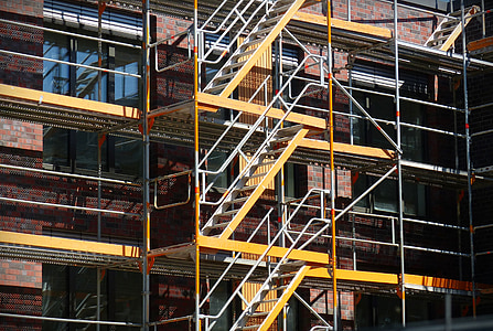 yellow and gray metal scaffolding beside building thumbnail