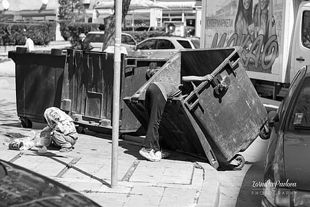 person looking in dumpster thumbnail