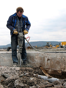 man holding jackhammer during daytime thumbnail