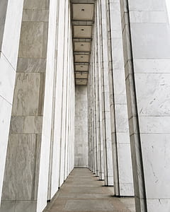 selective focus photography of white concrete tiled panel building pillars thumbnail