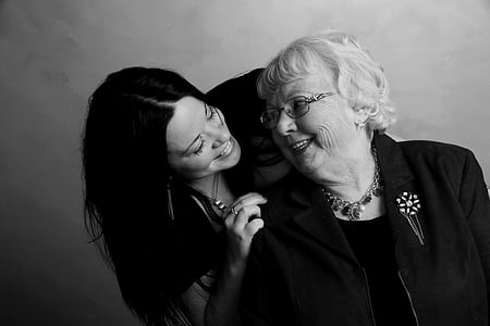 black haired woman holding white haired woman thumbnail