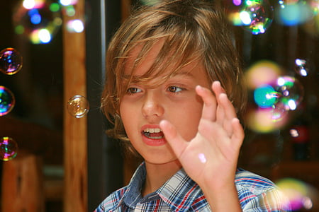 boy playing with bubbles focus photography thumbnail