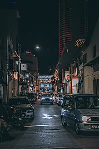 white car between cars at nighttime thumbnail
