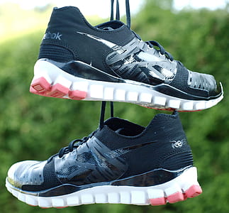 selective focus photo of black-and-white Reebok running shoes thumbnail