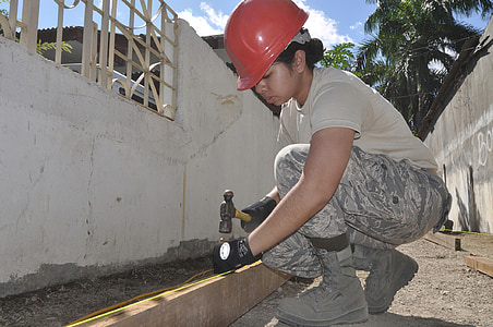 woman holding nail and hammer outdoor thumbnail