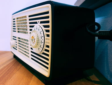 white and black transistor radio on brown wooden surface thumbnail