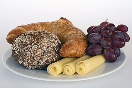 purple grapes with croissant and roll cheese on plate thumbnail