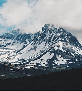 photo of snow covered mountain range under clear sky thumbnail