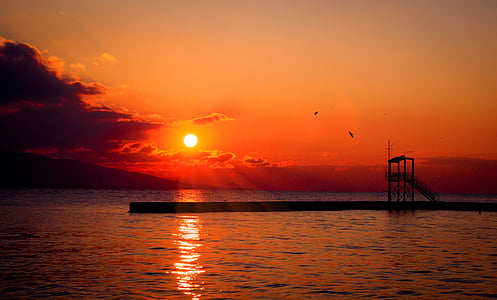 silhouette of bridge under sunset thumbnail