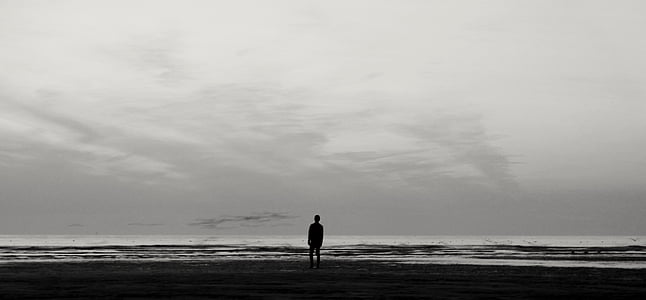 silhouette of person standing person near water thumbnail