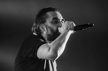 Man Singing Wearing Black Polo Shirt thumbnail