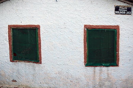 white painted wall with two open windows thumbnail