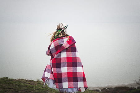 woman wearing red, white, and black plaid poncho thumbnail