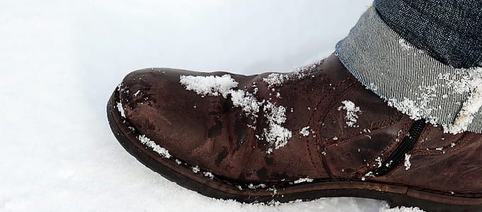brown boot covered with snow thumbnail