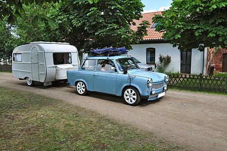 blue coupe parked near white camper trailer at daytime] thumbnail