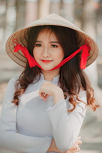 Photography of a Woman Wearing Asian conical hat thumbnail