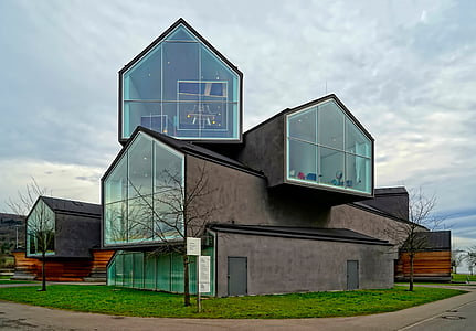 low-angle photography of glass wall building near leafless trees thumbnail