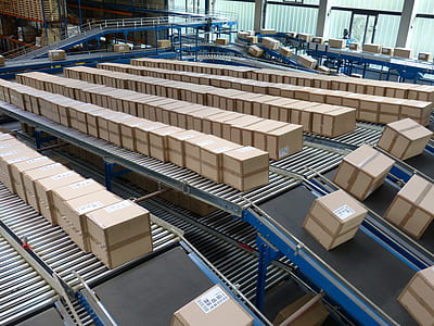 brown cardboard boxes moving along conveyor belt thumbnail