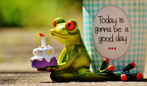 green frog figurine holding a cake thumbnail