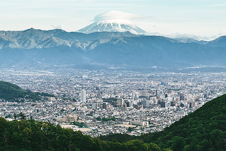 buildings near mountain at daytime thumbnail