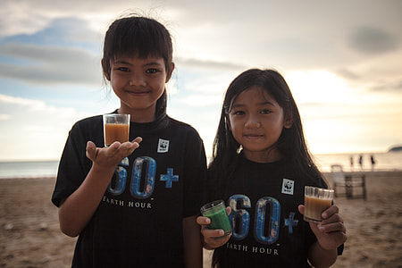 two girls holding glasses filled with beverage thumbnail