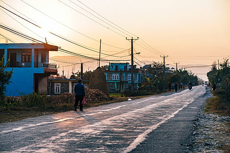 man standing on side of road at daytime thumbnail