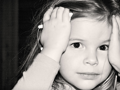 girl holding her head grayscale photography thumbnail