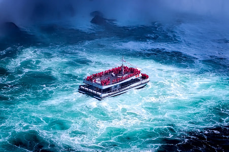 people on board of white and black passenger boat thumbnail