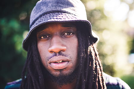 selective focus photography of man wearing bucket hat thumbnail